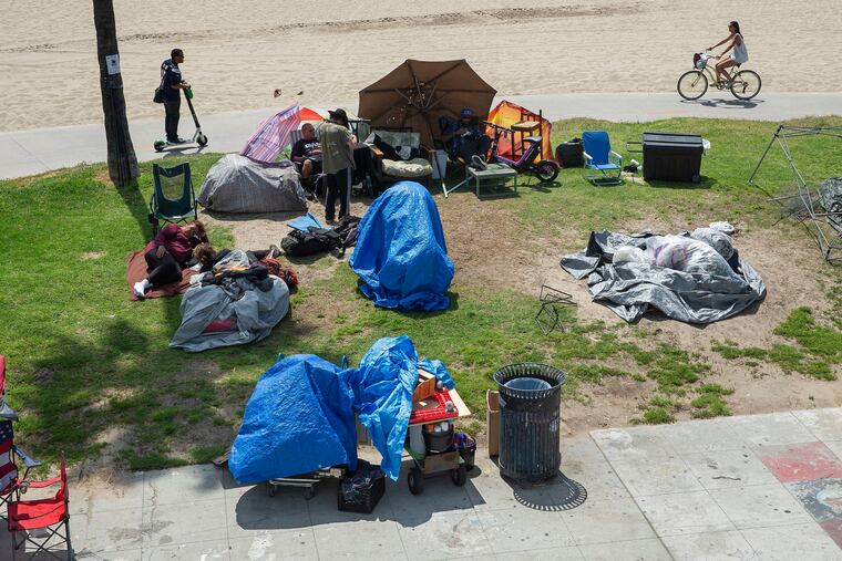A homeless encampment on a boardwalk in Venice Beach, Calif.