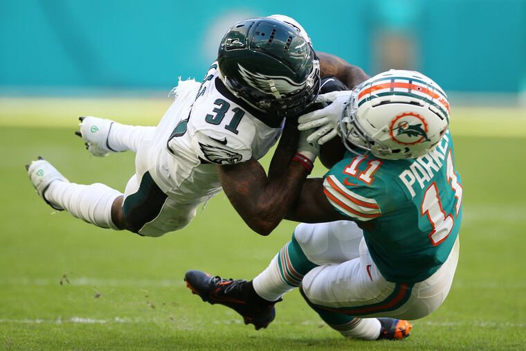 Miami Dolphins wide receiver DeVante Parker (11) makes a catch despite pressure from Eagles cornerback Jalen Mills (31) in the fourth quarter.