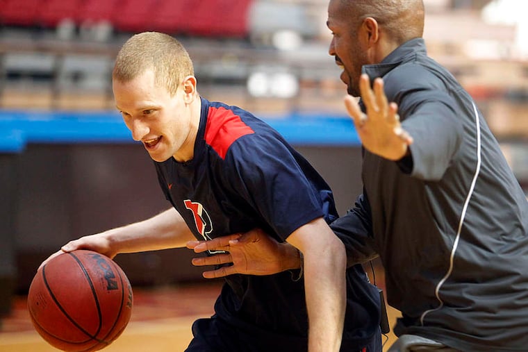 Penn guard Zach Rosen tries to elude head coach Jerome Allen at practice. Before becoming his coach, Allen worked with Rosen.