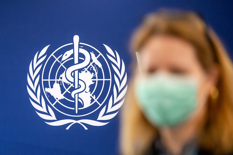 A person is wearing a protective face mask in front of the WHO logo, during the media regarding the epidemic of Ebola disease, during a press conference at the World Health Organization (WHO) headquarters in Geneva, Switzerland, Friday, May 22, 2026.