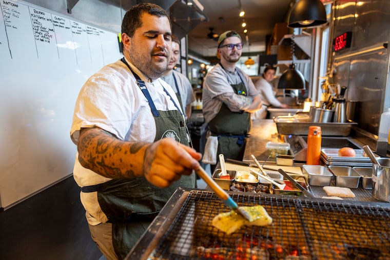 Chef-partner at Emmett Evan Snyder grills a halibut over charcoal. Snyder won Breakout chef at the 2026 Tasties awards.