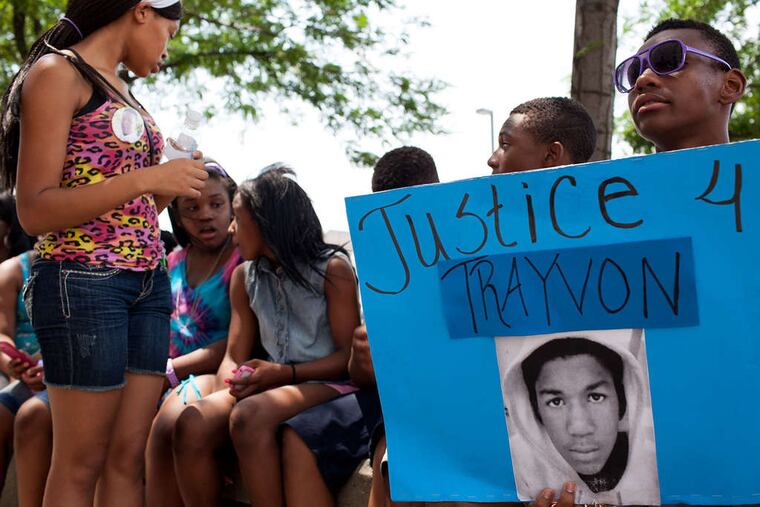 Tymere Barton, 15, of Camden , holds a sign in support of Trayvon Martin at City Hall in Camden. The marchers included children in a well-known Camden drill team. ANDREW RENNEISEN / Staff Photographer