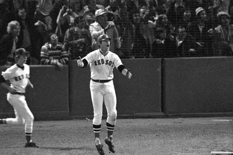 Boston Red Sox hitter Carlton Fisk reacts as he sees his 12th inning home run hit the left foul pole to win the sixth game of the World Series against Cincinnati, Oct. 21, 1975 in Boston's Fenway Park. (Harry Cabluck/AP file)