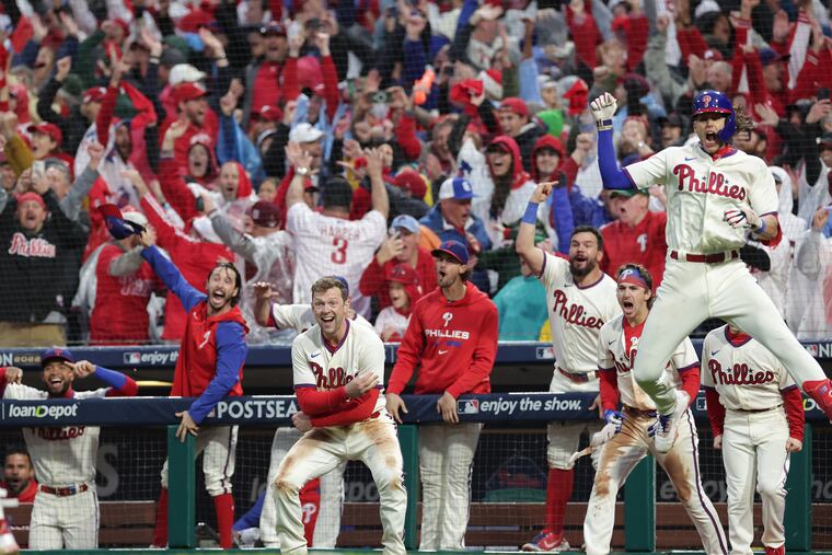 The Phillies dugout and fans react after Bryce Harper's decisive two-run homer in the eighth inning against the Padres.