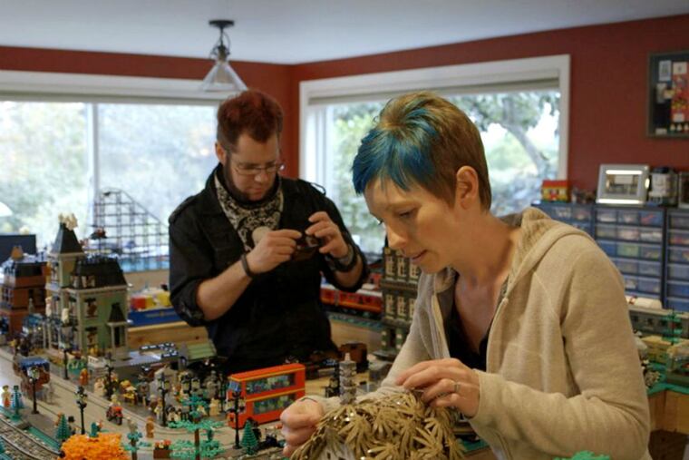 Dave and Stacy Sterling construct a model town out of Legos in “A Lego
Brickumentary.” The toys attract children and adults alike. (Radius)