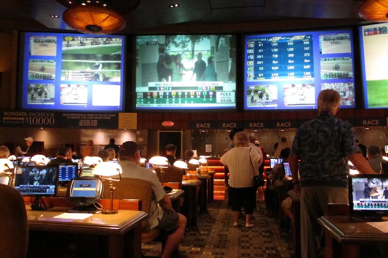 FILE – In this June 14, 2018, file photo, bettors wait to make wagers on sporting events at the Borgata casino in Atlantic City, N.J.