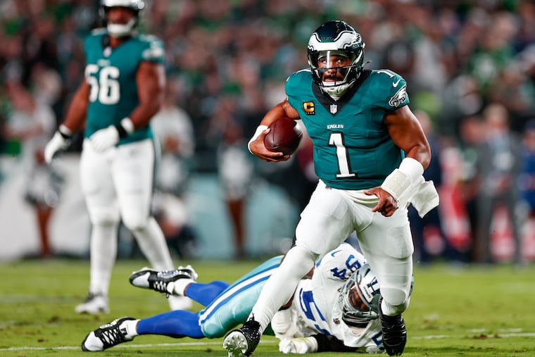 Jalen Hurts runs past Cowboys defensive end Marshawn Kneeland during the Eagles' Week 1 win.