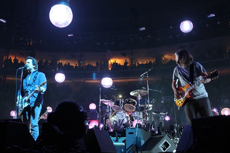 Lead singer Eddie Vedder, left and Stone Gossard, right of Pearl Jam rock the Wells Fargo Center, Monday, October 21, 2013. ( Steven M. Falk / Staff Photographer )