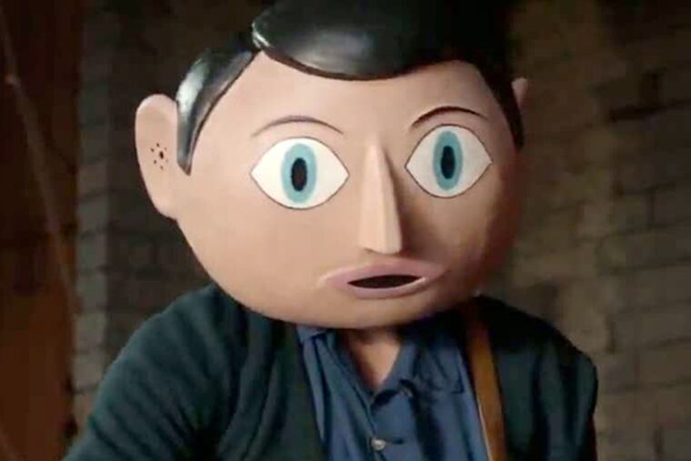 Michael Fassbender- his chiseled mug encased in a cartoonish papier-mâché head- as the title character, the nutty front man for a rock band, in Frank.