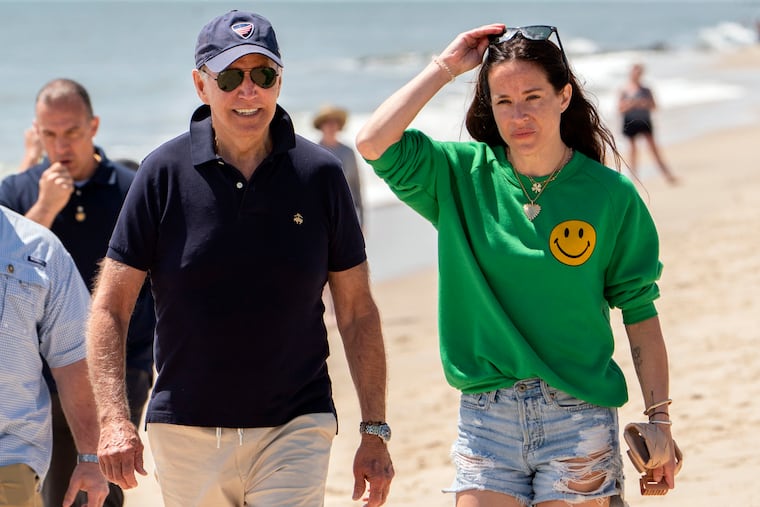 President Joe Biden walks on the beach with daughter Ashley Biden, in Rehoboth Beach, Del., in June.