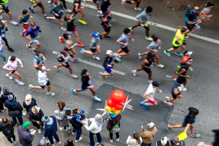 Runners on Walnut Street in Center City during the 2024 Philadelphia Marathon last year. Sunday's should be a dry run.