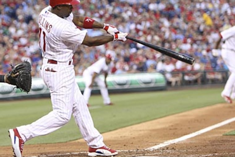 Jimmy Rollins drives in a run in the fourth inning against the Rockies on Wednesday. (Steven M. Falk/Staff Photographer)