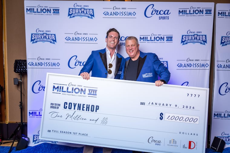 Chris Coyne (left) accepting his $1 million prize from Circa Sports owner and CEO Derek Stevens on Jan. 9 in Las Vegas. Circa Sports operates the sportsbook at the Circa Resort & Casino.