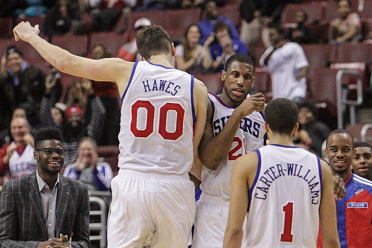 Thaddeus Young celebrates with teammates after hitting a three-pointer against the Bobcats putting them ahead three seconds left. (Steven M. Falk/Staff Photographer)