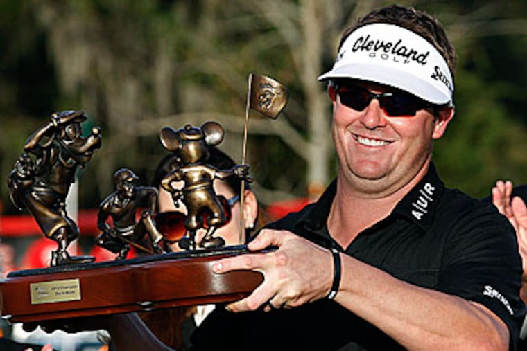Charlie Beljan holds up the trophy on the 18th green after winning the
Children's Miracle Network Hospitals golf tournament. (Reinhold Matay/AP)