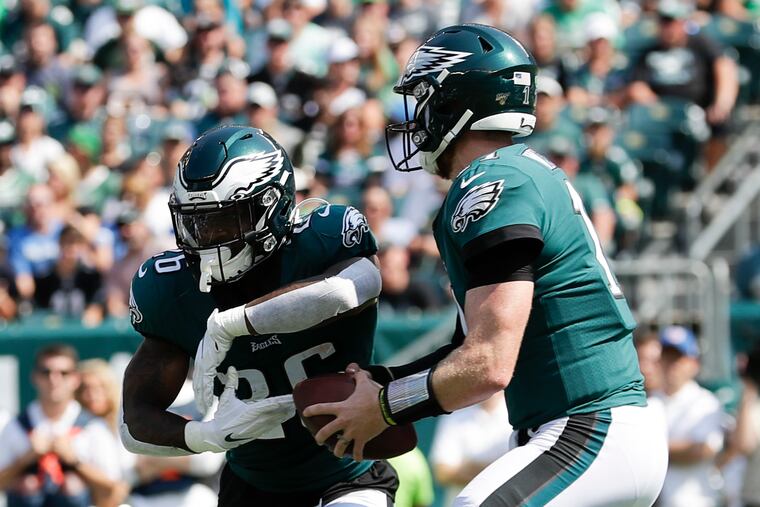 Eagles quarterback Carson Wentz fakes a handoff to Miles Sanders against the Detroit Lions.