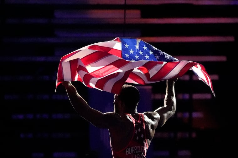 Jordan Burroughs celebrates after final match against Iran's Mohammad Ashghar Nokhodilarimi during the Wrestling World Championships in Belgrade, Serbia.