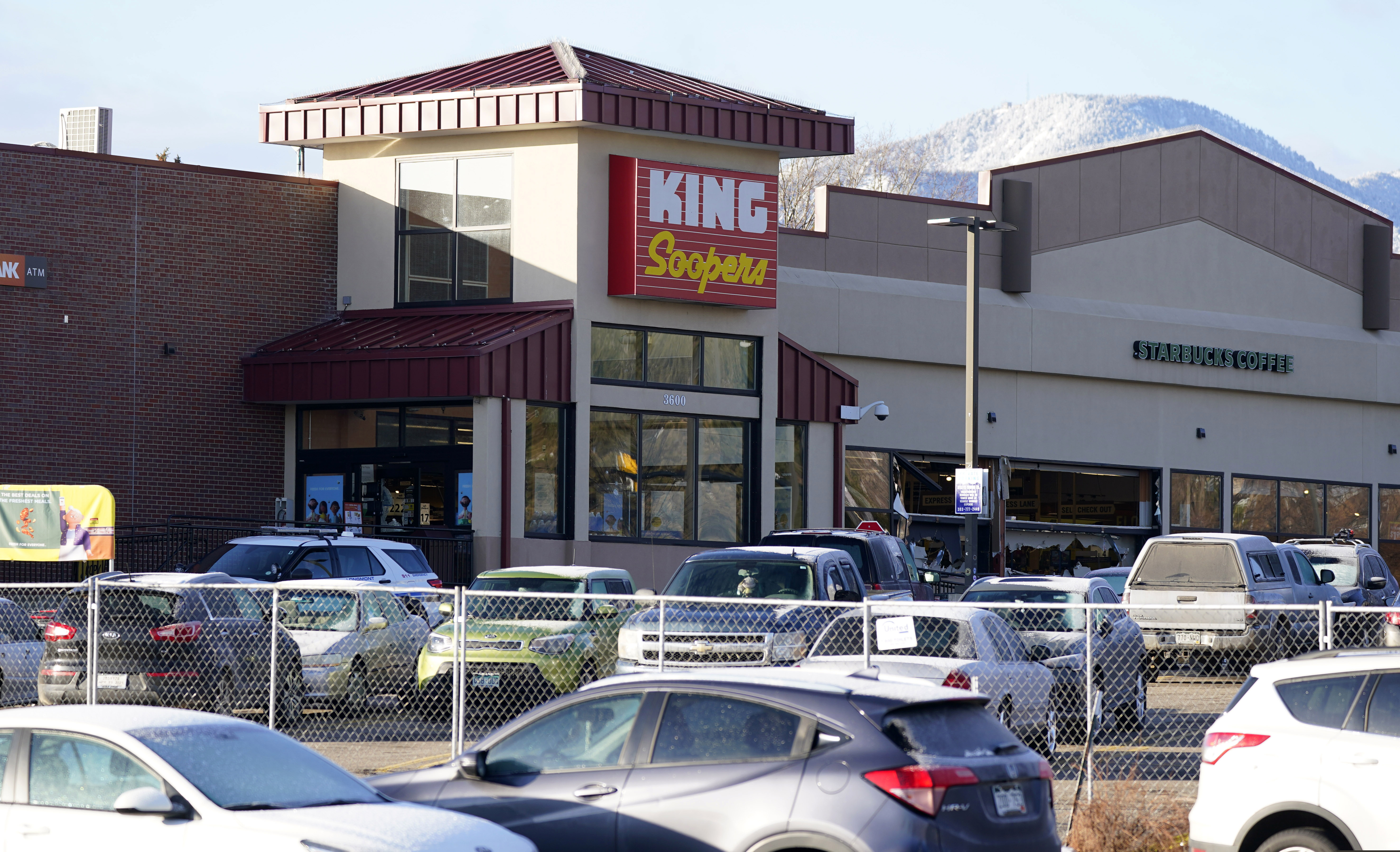A makeshift fence stands around the parking lot outside a King Soopers grocery store where 10 people were killed on Monday.