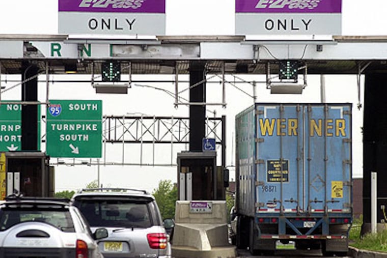 Cars and a truck go through the E-ZPass lanes at Exit 8A of the New Jersey Turnpike in Monroe Township, N.J. in this May 12, 2003, file photograph. (AP Photo / Daniel Hulshizer)