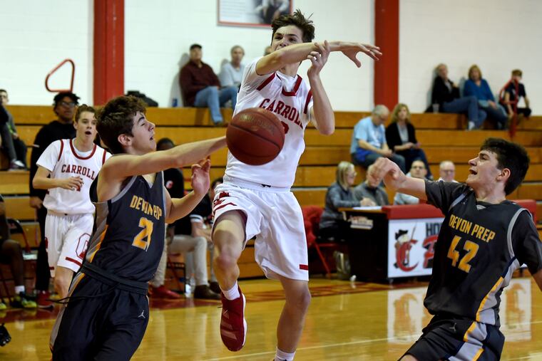 Archbishop Carroll's Ryan Park loses the ball as as he drives between Devon Prep's Justin Klauder (left) and Lucas Orchard.