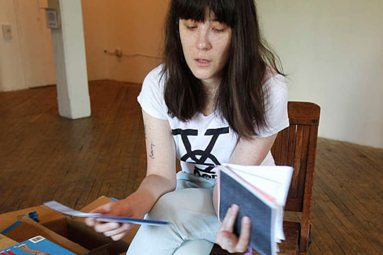 Beth Heinly cataloging her zine collection at the Vox Populi Studio in Center City. (AKIRA SUWA / Staff Photographer)