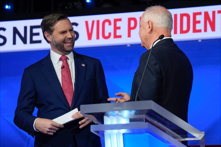 Sen. JD Vance (R., Ohio) talks with Minnesota Gov. Tim Walz after Tuesday's vice presidential debate in New York.