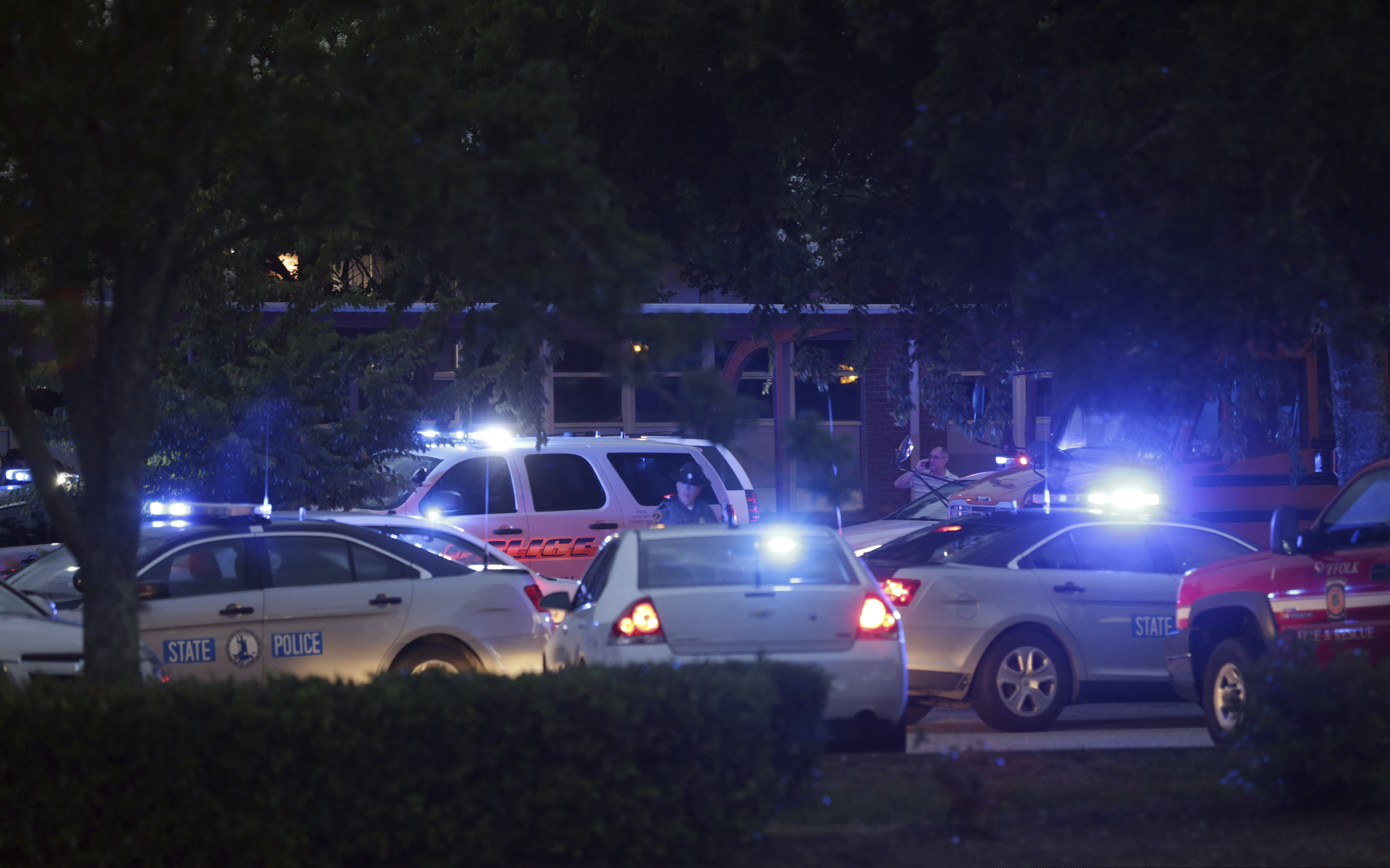 Emergency vehicles fill the parking lot at the Princess Anne Middle School in Virginia Beach, Va, on Friday, May 31, 2019.