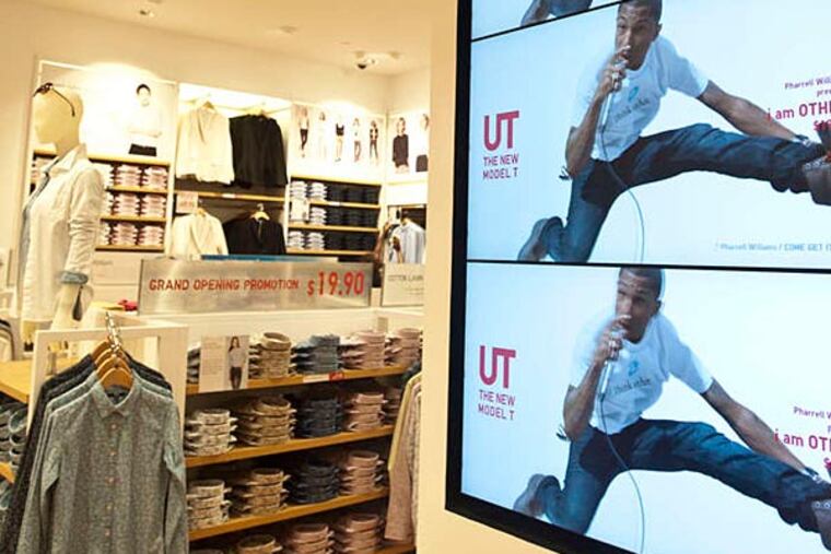 Some of the 46 video monitors in the Japanese-based fashion chain Uniqlo opening in the King of Prussia mall. (Ron Tarver/Staff
Photographer)