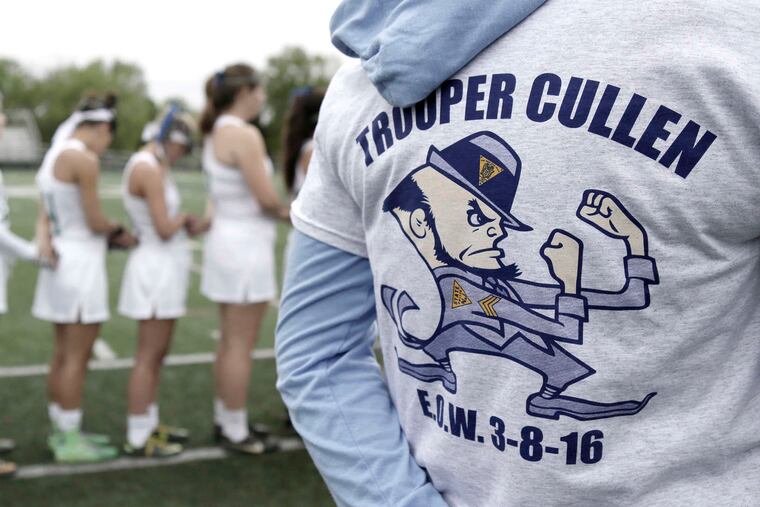 Camden Catholic girls' lacrosse players line up for a moment of silence for N.J. Trooper Sean Cullen, who was killed in a March traffic accident. ELIZABETH ROBERTSON / Staff Photographer