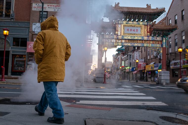 Sub-freezing temperatures send steam into the air at corner of North 10th and Arch streets in Philadelphia's Chinatown section on Friday morning.