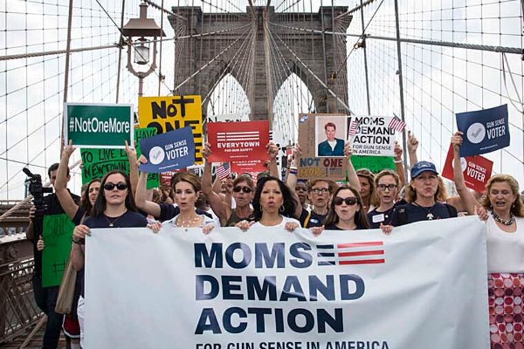 Moms Demand Action was one of the groups represented on the march across the Brooklyn Bridge in support of gun control. Many motorists honked their horns in support. (John Minchillo/Associated Press)