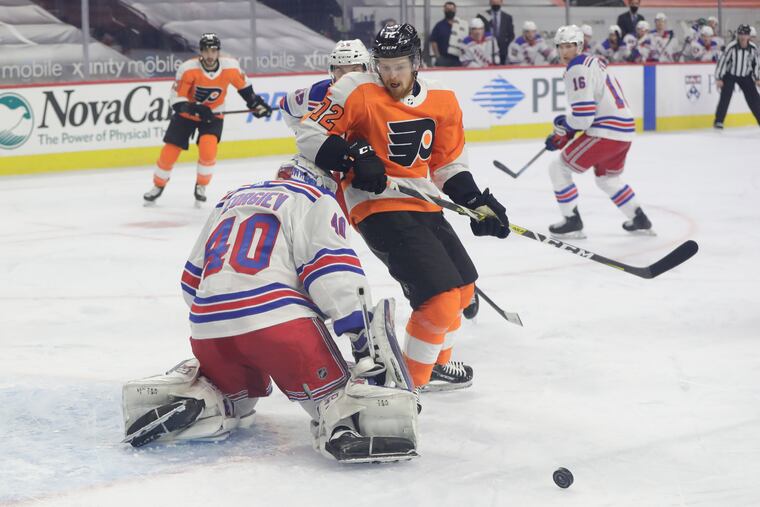 Flyers right winger David Kase runs into Rangers goaltender Alexandar Georgiev during the first period.