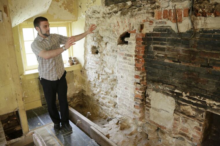Cory Gehris, weekend manager at Cliveden, gives a tour of the Chew family's 18th-century kitchen at the opening of the "Mixing Memories: Sharing History" exhibit there.