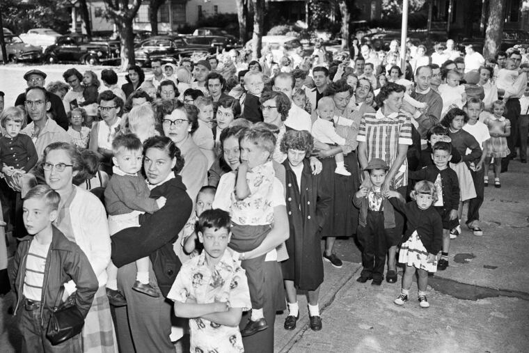 People wait to get the polio vaccine outside the Riverside Public School in Elmira, N.Y., in 1953.