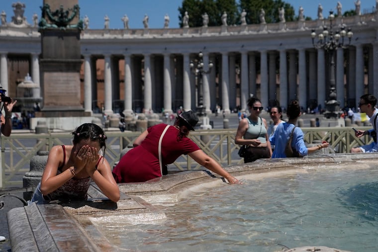 People refresh in a fountain after the Angelus noon prayer celebrated by Pope Leo XIV from the window of his studio overlooking St.Peter's Square, at the Vatican, Sunday, June 28, 2026.