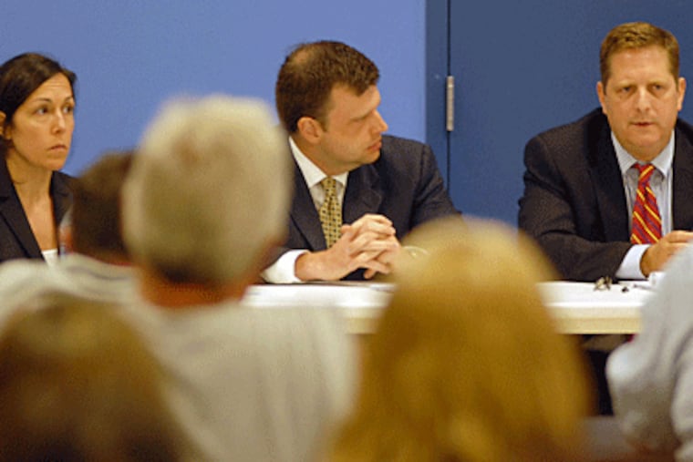 Philadelphia Academy Charter School board member Joe Resta (center) listens as Ballard Spahr attorneys Lisa Cuifolo (left) and Henry Hockeimer (right) present highlights of their 100-plus page report to parents, staff and board members. (Tom Gralish / Inquirer)