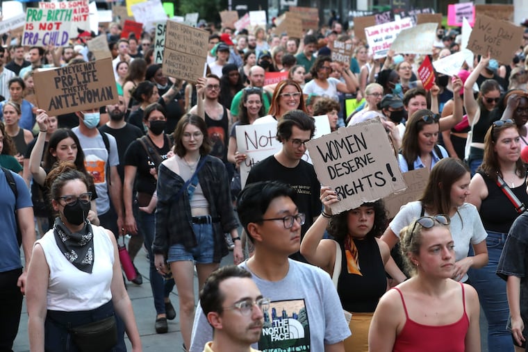 A crowd of abortion-rights advocates march down Market Street in Philadelphia, from City Hall to the federal courthouse, on Friday, June 24, 2022, after the U.S. Supreme Court overturned Roe v. Wade.