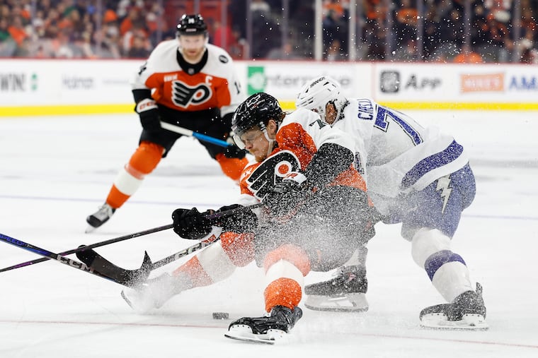 Flyers right wing Owen Tippett falls down skating with the puck against Tampa Bay Lightning center Anthony Cirelli during the second period on Saturday. The Flyers fell to the Lightning, 7-2.