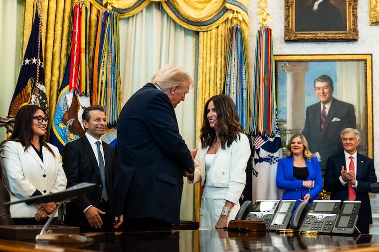 President Donald Trump greets in vitro fertilization advocate Samantha Busch during an October event in the Oval Office outlining plans to encourage employers to include IVF access in infertility coverage.