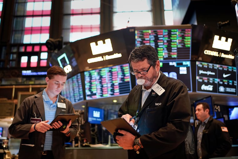 Traders work on the floor at the New York Stock Exchange.