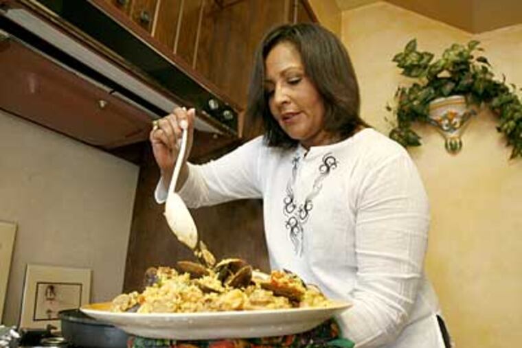 One of Laurie Linn Huggins’ favorite dishes is paella. She learned how to prepare it from "The New York Times 60-minute Gourmet by Pierre Franey," whose recipes, Huggins says, "are sophisticated simplicity - and rather quick to prepare." (CHARLES FOX / Staff Photographer)