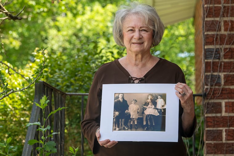 Karen Zeitz of South Philadelphia holds a picture of her grandparents and their three children. The two sons and daughters were left motherless after Molly Clara Rosenfeld died during the 1918 flu pandemic. The loss reverberated through Karen's family, and took on special significance during the coronavirus pandemic.