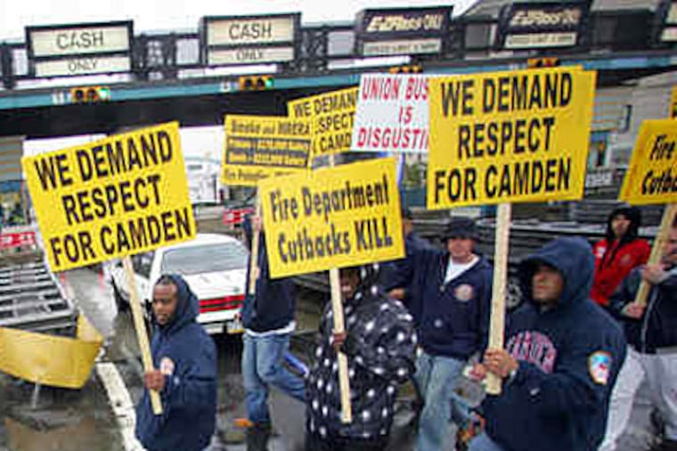 Camden firefighters block traffic at the Ben Franklin tolls. The workers were angry at cutbacks and other policies imposed by the city's state-appointed chief operating officer, Theodore Z. Davis. (DAVID SWANSON / Staff Photographer)
