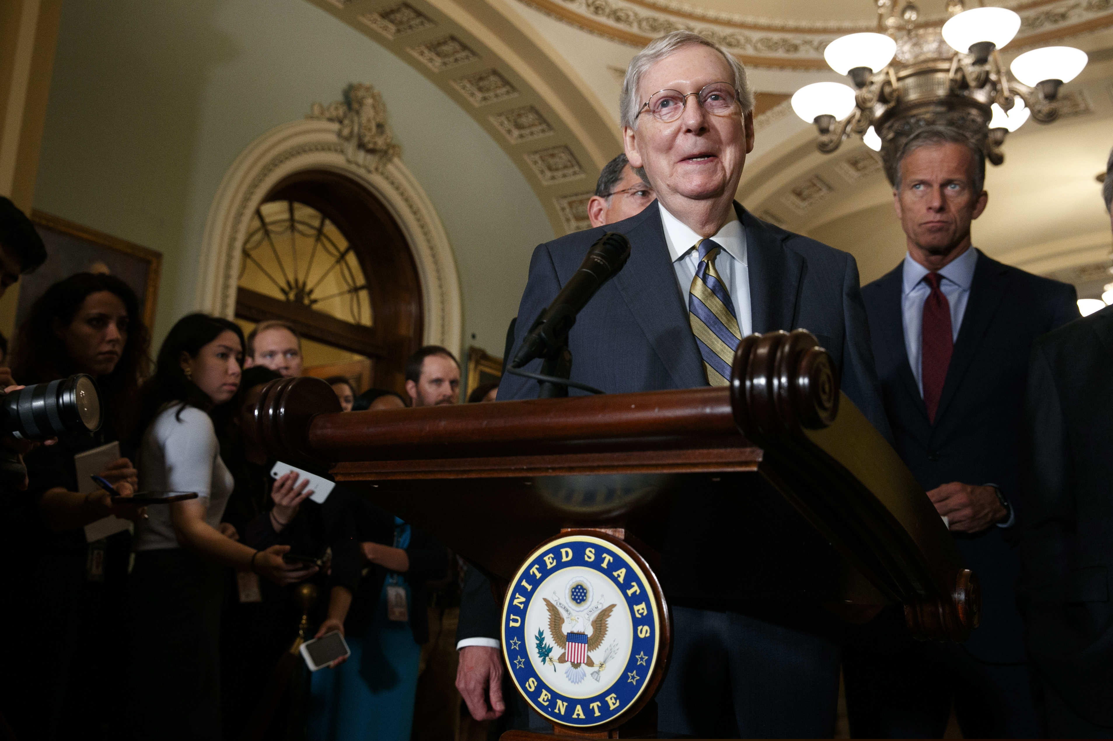 Senate Majority Leader Mitch McConnell of Ky., smiles as he speaks to members of the media, next to Sen. John Thune, R-S.D., right, Tuesday Sept. 24, 2019, after a Republican policy luncheon on Capitol Hill in Washington.