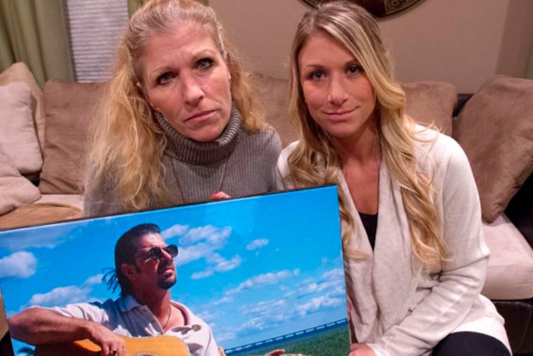 Lisa Kingston holds a photo of Danny DeGennaro, circa 1998, at 45. She is with their daughter, Gia DeGennaro Pape.