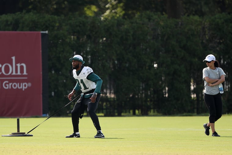 Eagles’ Jalen Mills works with Shireen Mansoori, director of rehabilitation, during Eagles training camp in Philadelphia, PA on July 31, 2019.