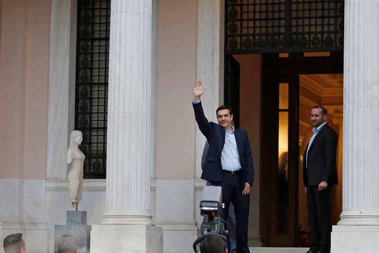 Alexis Tsipras , Greece's new anti-austerityprime minister, waves to supporters in Athens. On his first day in office, the 40-year-olddid much differently. Story, A6. Bloomberg