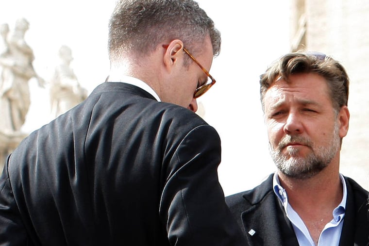 Actor Russell Crowe, right, attends Pope Francis' general audience in St. Peter's Square at the Vatican, Wednesday, March 19, 2014. Crowe and the makers of the big-budget film "Noah" attended Pope Francis' general audience Wednesday but didn't get what they most wanted: a papal meeting and photo-op. Crowe had lobbied hard for a papal thumbs up for his film and the ensuing publicity a Francis blessing would bring. The film has been banned in much of the Muslim world because of its depiction of the prophet, while U.S. conservatives have complained it took liberties with the Biblical account of the flood. (AP Photo/Str)