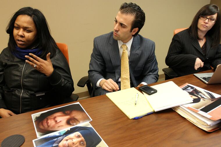 Micheal Allen, left, was paroled to a North Philly halfway house last spring. After mounting tensions with another woman paroled to the same halfway house, Kintock Center, the woman attacked Allen in her bed last May by beating her with locks in a sock - splitting her face open and breaking her nose. Allen has hired a lawyer, who plans to sue the halfway house for systemic problems, including a lack of supervision and security. She is seen with her lawyers Bob Lynch, center and Amy Sokolson, right. ( DAVID MAIALETTI / Staff Photographer )