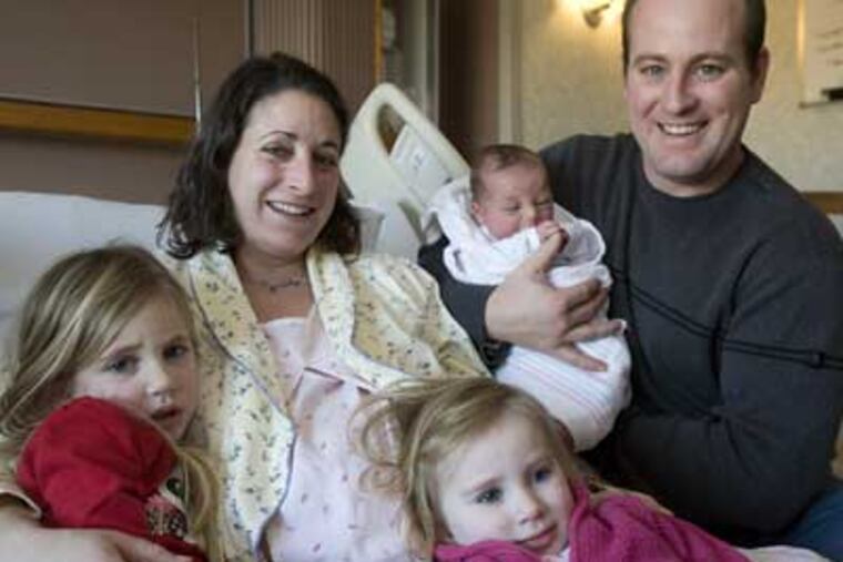 Luke Timothy Raines, the first 2009 baby born in the region at 12:07 a.m., with his family (left to right, Emma, mom Christina, Morgan, and dad Timothy) at Chester County Hospital in West Chester. (Ed Hille / Staff Photographer)